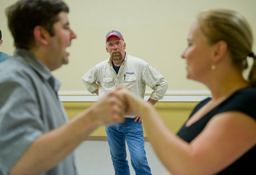 Mark Wheelus (center) watches as Mirka Roach and Dance 4 Fun instructor Matthew Johnson demonstrate a new dance step during a swing class in Lawrenceville on Monday, April 15, 2013. 