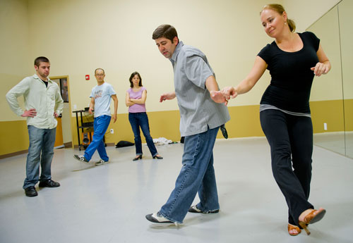 Mirka Roach (right) and Dance 4 Fun instructor Matthew Johnson (center) demonstrate a new dance step as Jason Iacono, Taeook Kwon and Kim Dyckman watch during a swing class in Lawrenceville on Monday, April 15, 2013. 