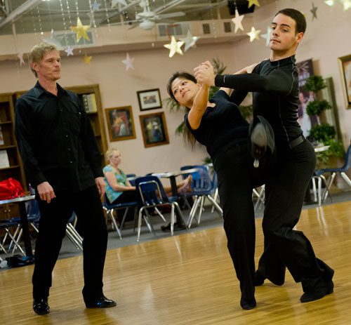 Jessie Lin (center) and Luca Guidoni move around the dance floor during a private lesson with instructor Jim Richmond (left) at Atlanta Ballroom Dance Centre in Sandy Springs on Wednesday, April 17, 2013.