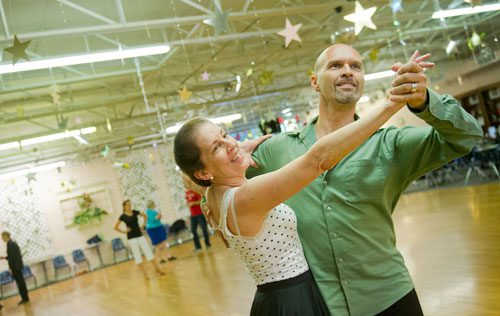 Instructor Rainier Rics (right) leads Kitty Canupp around the dance floor during a private lesson at Atlanta Ballroom Dance Centre in Sandy Springs on Wednesday, April 17, 2013. 
