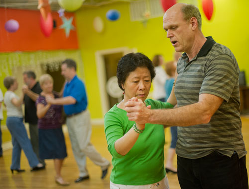Bruce Herr (right) leads Sunghee Kim around the dance floor during a class at Atlanta Ballroom Dance Centre in Sandy Springs on Wednesday, April 17, 2013. 
