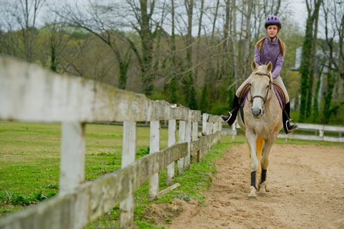 Julia Fleischer rides her horse around the training ring as she takes a lesson with Atlanta In-Town Riding Academy at Little Creek Horse Farm in Decatur on Wednesday, April 3, 2013. 