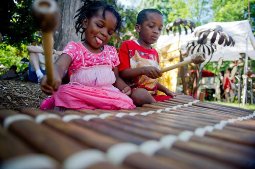Leela Washington-Crowther (left) and her brother Aholiab play on a African balafon during the Decatur Arts festival in downtown Decatur on Saturday, May 25, 2013. 