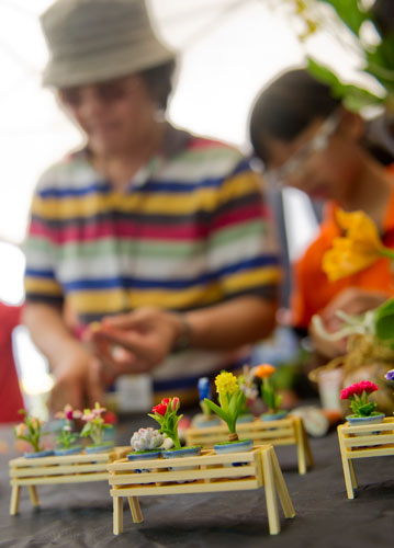 Kowit Jitpraphai (left) and his daughter Supakan design clay orchids during the Decatur Arts festival in downtown Decatur on Saturday, May 25, 2013.