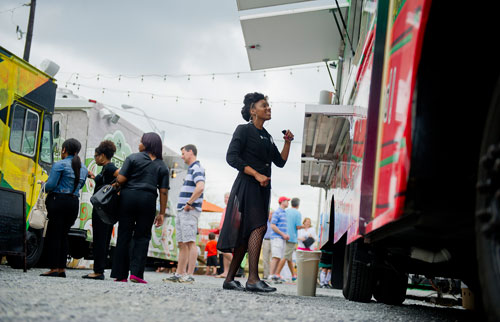 Lovette Bethel (right) talks to one of the food truck vendors at the Atlanta Food Truck Park & Market off of Howell Mill Road on Saturday, May 11, 2013.