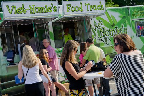 Doris Bloom (right) and Andra Wildstein eat food from the Viet-Nomie's food truck in Roswell on Thursday, May 16, 2013. 