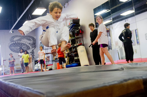 Andres Eskildsen-Lee (center) tries to jump as far as he is able during Kung Fu Camp at Highland Martial Arts in the Virginia Highlands neighborhood of Atlanta on Wednesday, June 12, 2013.