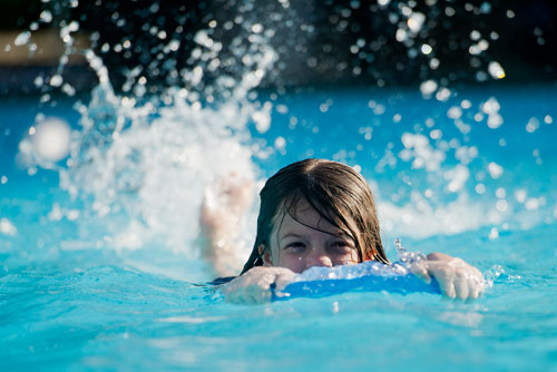 Evie Vesper uses a kickboard to keep her head above water as she swims laps of freestyle during practice for the Decatur Gators summer league swim team at Glenlake Park pool in Decatur on Wednesday, May 22, 2013. 