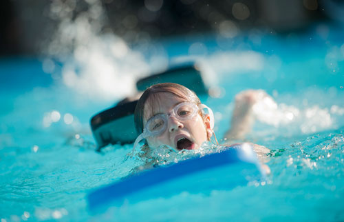 Anna Taggart uses a kickboard to keep her head above water as she swims laps of freestyle during practice for the Decatur Gators summer league swim team at Glenlake Park pool in Decatur on Wednesday, May 22, 2013. 