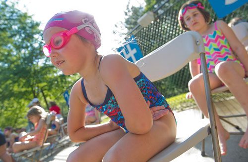 Aspen Alder (left) and Zyanya Martinez wait in line for their next event to be called during a practice swim meet for the Spalding Corners Sharks in Peachtree Corners on Thursday, May 23, 2013.