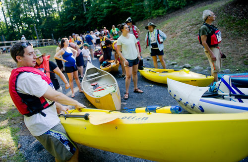 Dave Gewertz (left) holds his kayak as he waits in line for the start of the Back to the Chattahoochee River Race & Festival in Roswell on Saturday, June 15, 2013.