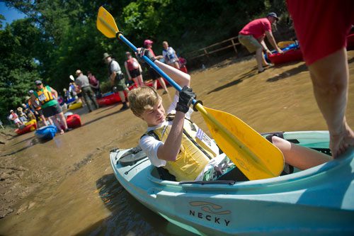 Charlie Stephens repositions his paddle as he moves into position for the start of the Back to the Chattahoochee River Race & Festival in Roswell on Saturday, June 15, 2013. 