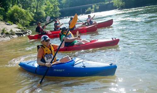 Christina Parkhurst (center) paddles her kayak as she takes off from the starting line during the Back to the Chattahoochee River Race & Festival in Roswell on Saturday, June 15, 2013. 