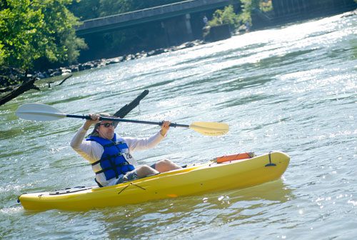 Jonathan Johnson paddles his kayak as he takes off from the starting line during the Back to the Chattahoochee River Race & Festival in Roswell on Saturday, June 15, 2013.