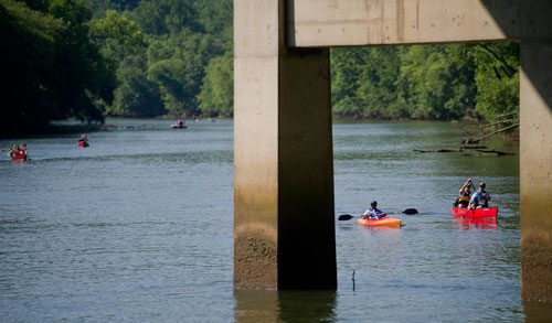 Canoers and kayakers paddle down the Chattahoochee River as they near Don White Memorial Park in Roswell on Saturday, June 15, 2013. 