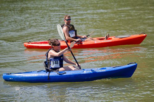 Christy Fountain (left) paddles past Scott Taylor as they near the finish line during the Back to the Chattahoochee River Race & Festival in Roswell on Saturday, June 15, 2013.