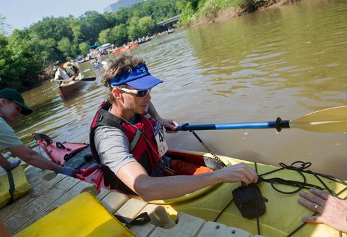 Sean Kinsey unclips his paddle as he prepares to exit his kayak at the take out point on the Chattahoochee River in Roswell on Saturday, June 15, 2013. 