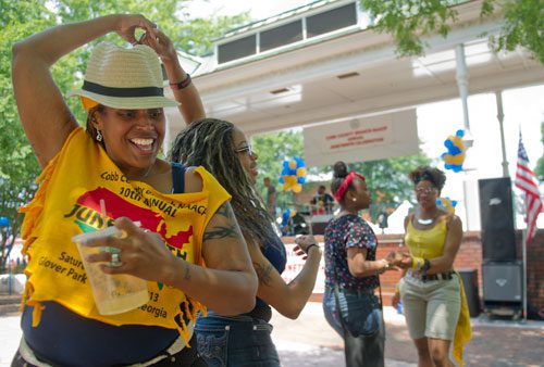 Akella Clore (left) dances with Deja Bolton as Aminah Khan dances with Kaia Bolton during the Cobb NAACP Juneteenth Celebration in Marietta Square on Saturday, June 15, 2013. 