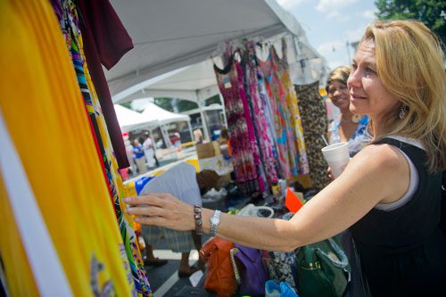 Lisa Faust (right) looks at sundresses for sale during the Cobb NAACP Juneteenth Celebration in Marietta Square on Saturday, June 15, 2013. 
