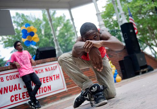 Matthew Gibbs (center), half of the performance duo Kinetix, performs with James D. Love during the Cobb NAACP Juneteenth Celebration in Marietta Square on Saturday, June 15, 2013. 