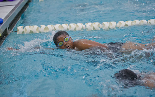 Jonathan Calhoun (top) stretches for the edge of the pool as he tries to beat Omar Greene in a sprint lap during practice for the City of Atlanta Dolphins at Adamsville Natatorium on Tuesday, May 28, 2013. 