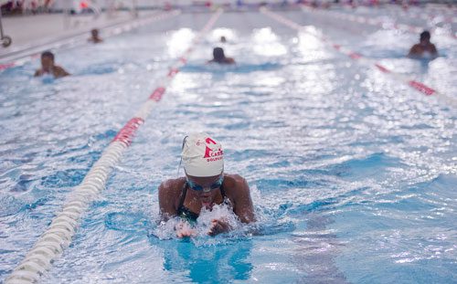 Zahra McIntosh (center) comes up for a breath as she swims a lap of breast stroke during practice for the City of Atlanta Dolphins at Adamsville Natatorium on Tuesday, May 28, 2013.