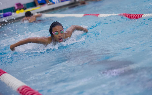 Sanaa Hardy comes up for a breath as she swims a lap of butterfly during practice for the City of Atlanta Dolphins at Adamsville Natatorium on Tuesday, May 28, 2013. 