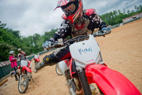 Students learn the proper way to handle a dirt bike safely during a class at the Motorcycle Safety Foundation campus in Alpharetta on Thursday, June 27, 2013.