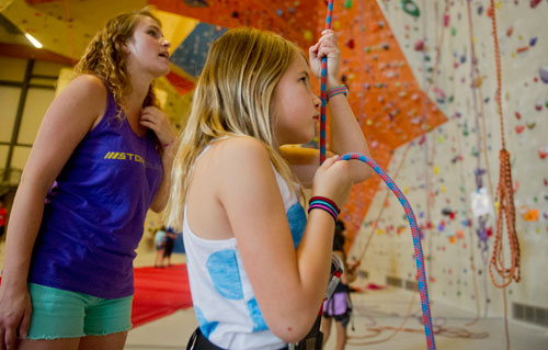 Sarah Schubert (right) belays for another climber as camp instructor Kara Mailman gives some instruction from the floor during climbing camp at the Stone Summit Climbing Center in Atlanta on Thursday, June 6, 2013. 