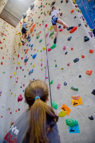 Emma Delman (right) nears the top of a rock wall during climbing camp at the Stone Summit Climbing Center in Atlanta on Thursday, June 6, 2013. 