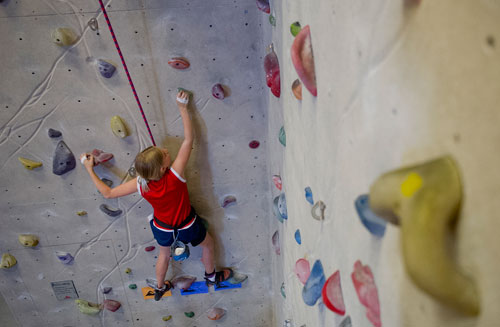 Alex Zerylnick makes her way up a rock wall during climbing camp at the Stone Summit Climbing Center in Atlanta on Thursday, June 6, 2013. 