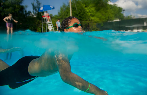 Laurent Keenan swims freestyle laps during swim team practice for the Decatur Gators at Glenlake Park pool in Decatur on Wednesday, May 22, 2013.