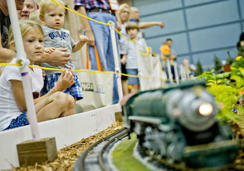 Avery Kmoch (left) and her brother Nolan watch a train pass as they look at the Georgia Garden Railroad Society's display during the 23rd Annual Nation Train Show at the Cobb Galleria Centre in Atlanta on Saturday, July 20, 2013. 