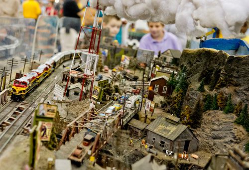 A train runs down its tracks as part of the Ark-La-Tex Modular Society's display during the 23rd Annual Nation Train Show at the Cobb Galleria Centre in Atlanta on Saturday, July 20, 2013. 