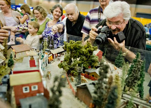 Terry Foshee (right) takes a photograph of the Ark-La-Tex Modular Society's display during the 23rd Annual Nation Train Show at the Cobb Galleria Centre in Atlanta on Saturday, July 20, 2013. 