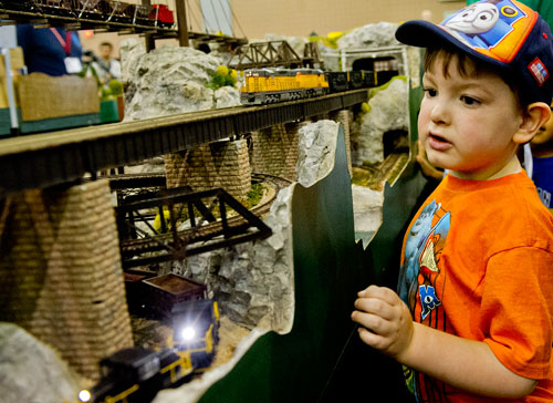 Noah Mote watches HO scale trains run down the tracks of the Atlanta Interlocking Model Railroaders' display during the 23rd Annual National Train Show at the Cobb Galleria Centre in Atlanta on Saturday, July 20, 2013. 