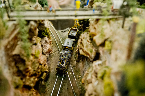 A train runs down its tracks as part of the Ark-La-Tex Modular Society's display during the 23rd Annual Nation Train Show at the Cobb Galleria Centre in Atlanta on Saturday, July 20, 2013. 
