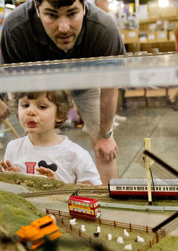 Luke Ribeiro (left) squishes his face against plexiglass as he and his father Scott look at the Ark-La-Tex Modular Society's display during the 23rd Annual Nation Train Show at the Cobb Galleria Centre in Atlanta on Saturday, July 20, 2013. 