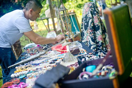 Carl Martinez arranges jewelry at his booth during the Town Meets Country pop up market at the Wren's Nest in Atlanta on Sunday, July 28, 2013.