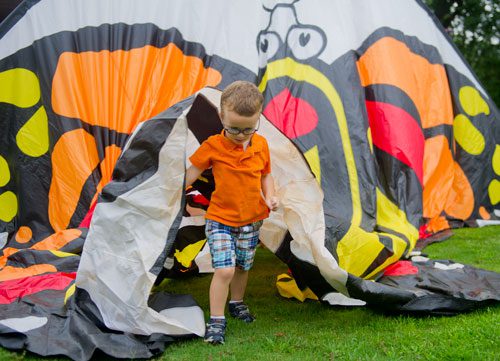 Landon Davidson makes his way through a butterfly tent during the 14th annual Flying Colors Butterfly Festival at the Chattahoochee Nature Center in Roswell on Saturday, July 13, 2013.