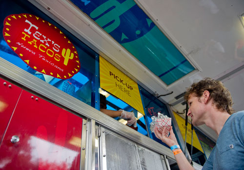 Ben Carlton picks up his order from the Texas Tacos truck during the Atlanta Street Food Festival at Piedmont Park on Saturday, July 13, 2013. 