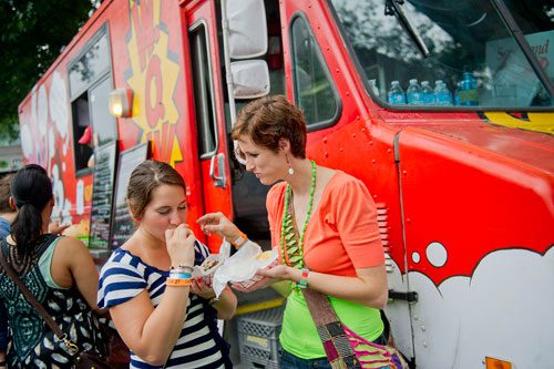 Natalie Christopher (left) and Lisa York taste their food from the Wonderlicious on Wheels truck during the Atlanta Street Food Festival at Piedmont Park on Saturday, July 13, 2013. 
