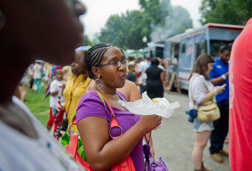 Shanita Loftin (center) stands in line during the Atlanta Street Food Festival at Piedmont Park on Saturday, July 13, 2013. 