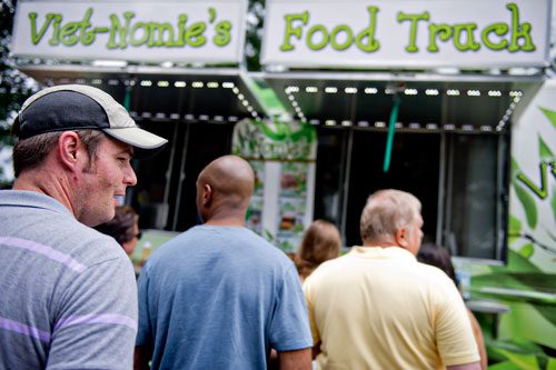 Josh Mello stands in line to buy food from Viet-Nomie's Food Truck during the Atlanta Street Food Festival at Piedmont Park on Saturday, July 13, 2013. 