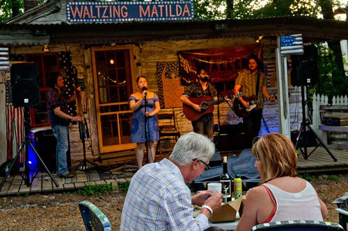 Moly Barnes and her husband Mark eat dinner while they listen to Billy Lyons, Tiffany Blalock, Jason Waller and Zac Caplan of the band Waller perform on stage at Matilda's Under the Pines in Alpharetta on Saturday, July 13, 2013. 