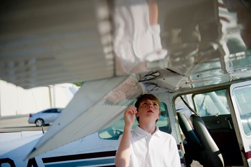 Rob Trotter performs a pre-flight check of a single engine Cessna Skyhawk before taking off from Dekalb-Peachtree Airport in Atlanta during aviation camp on Saturday, June 15, 2013. 