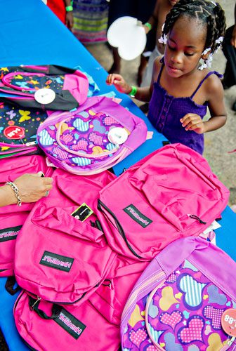 Christuana Smith picks out the perfect backpack during the Hosea Feed the Hungry & Homeless' 8th Annual Back to School Jamboree at Turner Field's Blue Lot in Atlanta on Saturday, July 20, 2013. 