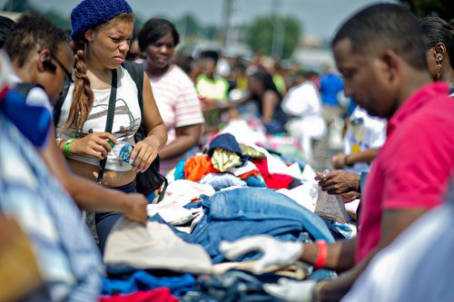 Amy Gomez (left) picks out clothes during the Hosea Feed the Hungry & Homeless' 8th Annual Back to School Jamboree at Turner Field's Blue Lot in Atlanta on Saturday, July 20, 2013. 