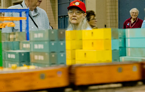 Dorrie Kniezan (center) watches trains pass along their tracks on one of the numerous displays during the 23rd Annual National Train Show at the Cobb Galleria Centre in Atlanta on Saturday, July 20, 2013.
