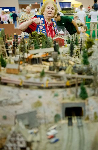 Tillie Caileff points out different features of the Ark-La-Tex Modular Society's display during the 23rd Annual National Train Show at the Cobb Galleria Centre in Atlanta on Saturday, July 20, 2013.